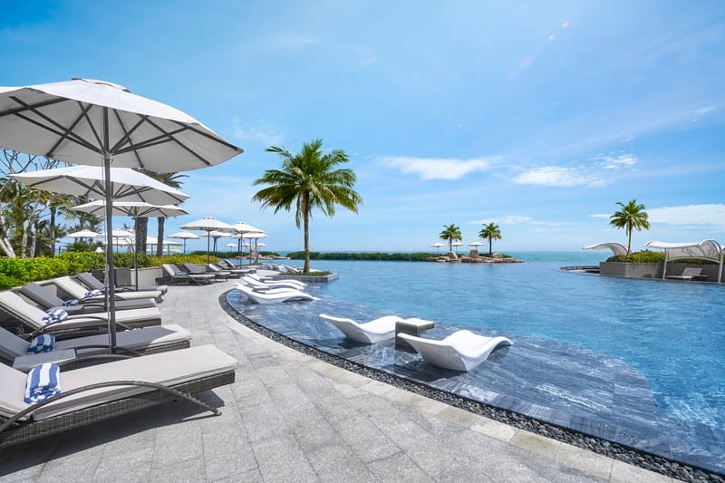 The swimming pool at The Grand Ho Tram provides a relaxing space during a ho tram vietnam journey. ho tram vietnam
